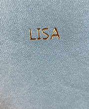 Load image into Gallery viewer, Image shows he name 'LISA' embossed onto the light blue journal with gold foil.