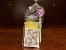 Load image into Gallery viewer, Image shows a closer image of the reverse of the plastic jar with silver screw top containing yellow sherbet. The jar is inside a cellophane wrapper with a pink lollipop and a white label shows the ingredient and nutritional information.