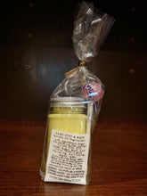 Load image into Gallery viewer, Image shows the reverse of the plastic jar with silver screw top containing yellow sherbet. The jar is inside a cellophane wrapper with a pink lollipop and a white label shows the ingredient and nutritional information.