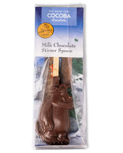 Load image into Gallery viewer, Image shows the Gruffalo milk chocolate stirrer spoon in its packaging with an illustration from The Gruffalo's Child. Milk chocolate stirrer spoon is in the shape of the Gruffalo.