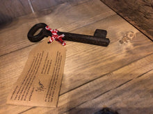 Load image into Gallery viewer, Image of Festive Entry Key - a metal decorative key tied with bakers twine and a kraft paper label showing the reverse information