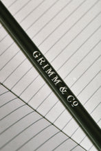 Load image into Gallery viewer, Close up details of lettering on one side of a Word Wand, otherwise known as a black pencil with a black eraser at the top. The silver lettering in the image reads 'Grimm & Co.'