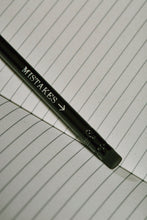 Load image into Gallery viewer, Close up details of lettering on a Word Wand, otherwise known as a black pencil with a black eraser at the top. The silver lettering in the image  reads 'Mistakes' with an arrow pointing towards the eraser.