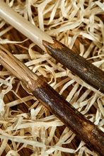Load image into Gallery viewer, Close up image of two handmade starter wands. Wooden decorative wands with polished bark handles and stripped bare polished wooden shafts. Woods are natural shades with grain pattern. 
