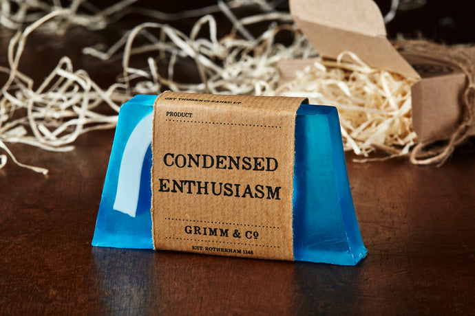 Image of Condensed Enthusiasm bar, otherwise known as an ocean scented soap slice, it is blue with a white wave shape inside the slice