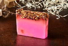 Load image into Gallery viewer, Image of Grandma&#39;s Scabs bar, otherwise known as a pink rose scented soap slice topped with dried rose petals, shown without kraft paper label