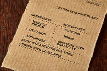 Load image into Gallery viewer, Image shows kraft paper label for Human Phlegm bar, a melon scented soap slice. Label lists the faux ingredients and side effects.