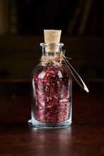 Load image into Gallery viewer, Image of Happily Ever After, a small decorative glass bottle with cork containing dried rose petals and tied with twine and a kraft paper label