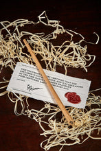 Load image into Gallery viewer, Image of a medium handmade advanced wand, wooden decorative wand stamped with a black Grimm & Co 'G' monogram at the base of the handle. Wand has three dots of sterling silver at the tip, wand wood is a natural pale colour and comes with a wax sealed certificate of authenticity