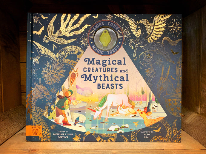 Image shows the hardback book Magical Creatures and Mythical beasts with coloured illustrations and gold foil line drawings. The UV torch sits inside the front cover visible from the outside.