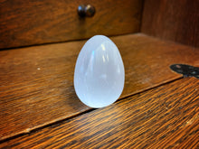 Load image into Gallery viewer, Image shows a close up view of  the egg shaped Blue Moon Crystal (selenite crystal).
