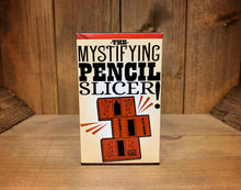 Load image into Gallery viewer, Image shows the front of the box for the Pencil Slicer. It has an illustration showing the parts of the trick included.