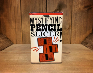 Image shows the front of the box for the Pencil Slicer. It has an illustration showing the parts of the trick included.