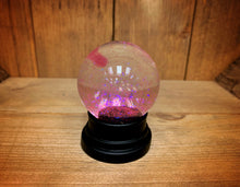 Load image into Gallery viewer, Image of the pink glitter globe after being shaken.