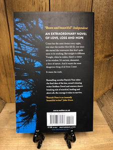 Image of the back cover of the book A Monster Calls with a black background and a repeat of the blue sky and silhouetted tree illustration from the front covrer.