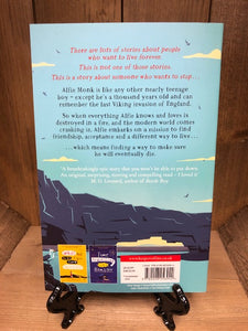 Image of the back cover of The 1,000 Year Old Boy with a continuation of the blue cliff illustration beneath the blurb.
