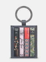 Load image into Gallery viewer, Image shows a grey leather keyring with metal ring stamped with YOSHI branding. Keyring shows 4 applique leather book spines with Bronte sisters books such as Jayne Eyre and Wuthering Heights.