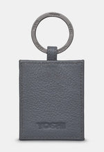 Load image into Gallery viewer, Image shows the back of the Bronte leather keyring with a metal ring stamped with YOSHI branding. The leather is also embossed with YOSHI at the bottom.