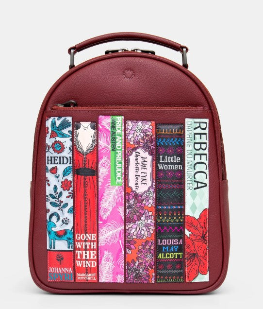 Image shows a cherry red leather backpack with double top zipper and carry handle, front zip pocket and 6 appliqued book spines featuring classic books written by female authors and with female protagonists such as Heidi, Little Women and Gone With The Wind.