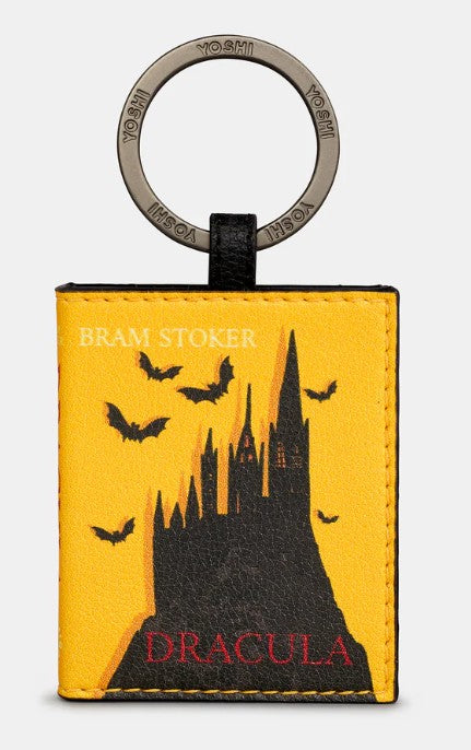 Image shows a PU leather keyring with stamped metal ring branded with YOSHI. Design resembles the book of Dracula with a front cover featuring a silhouetted castle and flying bats. The title is printed in red text and the author in white.