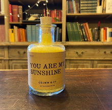 Load image into Gallery viewer, Image of a glass potion bottle filled with yellow bath salts. The bottle label reads: You Are My Sunshine