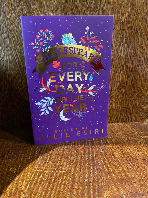 Image shows the front cover of the book Shakespeare fFor Every Day of the Year. The cover is purple with gold foil lettering and decorated with illustrations of flowers, fairies, leaves a crescent moon and Yorick's skull.