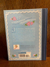 Load image into Gallery viewer, Image shows the back cover of the book Pride &amp; Prejudice - A Book to Table Classic. The cover is pastel blue with a navy blue linen spine. There are illustrations of icing sugar flowers decorating the cover. The text is white. There is a photograph of Martha Stewart at the bottom.