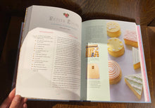 Load image into Gallery viewer, Image shows an open spread of the book Pride &amp; Prejudice - A Book to Table Classic, with a recipe for Petits Fours. There is a photograph on the right-hand side showing the petits fours decorated with white icing.