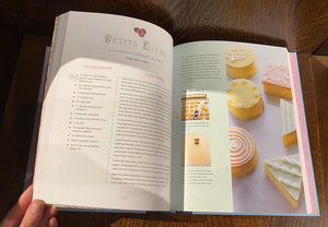 Image shows an open spread of the book Pride & Prejudice - A Book to Table Classic, with a recipe for Petits Fours. There is a photograph on the right-hand side showing the petits fours decorated with white icing.