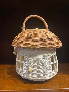 Rattan fairy house basket shown with brown handle on roof/lid. Basket has windows and a door with bead fastening.