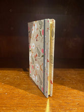 Load image into Gallery viewer, Image shows an A5 hardback notebook displayed to showcase the gold gilt edge.