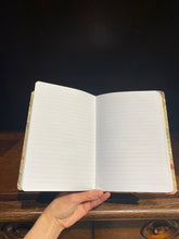 Load image into Gallery viewer, Image shows the open A5 notebook with lined pages.