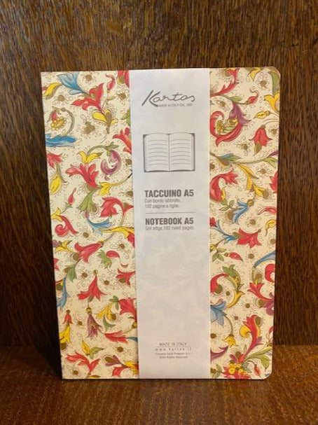 Image shows a patterned A5 notebook featuring colours including red, green, purple, orange and blue on an ivory background with gold powder finish. Design features a floral pattern called Florentia.