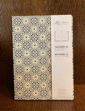 Load image into Gallery viewer, Image showing an A5 notebook with a geometric blue tile design with gold powder finish.