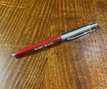 Load image into Gallery viewer, A red and chrome coloured retractable biro pen with the words &#39;Word Wand&#39; in white text against the red shaft.