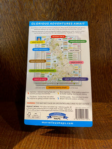 Image shows the back of a folded map of the UK with different colour coded routes, events and locations for adventures.