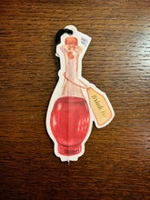 Load image into Gallery viewer, Image shows an illustrated flat paper pen in the shape of a corked bottle with red potion and illustration of a label saying Drink Me in gold foil.
