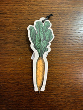 Load image into Gallery viewer, Image shows an illustrated flat paper pen in the shape of an orange carrot with green leafy top.