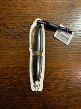 Load image into Gallery viewer, Image shows a fountain pen shaped flat paper pen with illustrated design in black and white with gold foil finish.