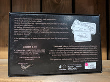 Load image into Gallery viewer, Image of the back of the box for Twists and Tales, a storytelling game created by children and young people at Grimm and Co. The box is dark blue with white text and has an illustration in the upper right corner of some of the card types within.