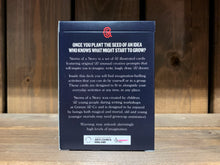 Load image into Gallery viewer, Image showing the back of the cardboard box for the card game Stems of a Story, created by children and young people during workshops at Grimm and Co. The box is dark blue, with white text.