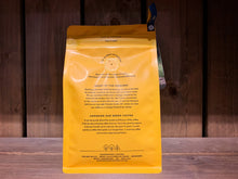 Load image into Gallery viewer,  Image of the back of the coffee packet. it is bright yellow, with black text.