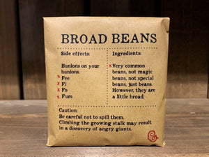 Image shows a packet of Broad Beans. It is a square, kraft brown paper packet., with black text printed in Appareo font. It says Broad Beans at the top, with magical ingredients and side effects printed underneath, and a magical 'caution' at the bottom.