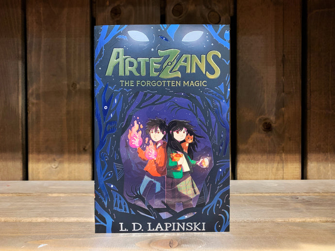 Image of the front cover of Artezans: The Forgotten Magic. The cover has an illustration of twins - a boy and a girl. The boy has a fire-like substance coming from his hands, and the girl has a glowing jar in one hand and a cat on her shoulder. They are surrounded by an abstract mix of monsters and trees in black and dark blue. At the top above the title is a glowing pair of white eyes.