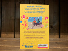 Load image into Gallery viewer, Image of the back cover of The Amazing Edie Eckhart. It is bright yellow, and the blurb is in blue text. Underneath the blurb is a drawing of a photograph surrounded by doodle drawings of lightning, stars, drinks, pizza , and theatre masks. The photograph shows a boy and a girl sitting on a bench at the beach.