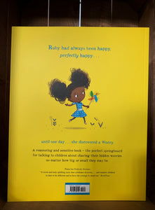 Image of the back of the book Ruby's Worry. The cover has a bright yellow background, and an illustration of the girl from the front cover skipping while holding a brightly coloured wind spinner toy. The blurb is written in black and blue text underneath.