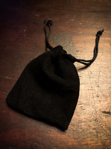 Image shows the mini black velvet drawstring pouch which the egg arrives in. Not shown, but also included, is a plastic egg stand
