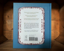 Load image into Gallery viewer, Image of the back of the book Nordic Tales. The back cover has a dark blue/teal background, and in the center the blurb is written in a white rounded rectangle, bordered by the same pattern as on the front.