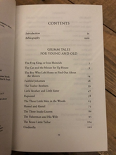 Load image into Gallery viewer, Image inside the hardback book Grimm Tales For Old and Young, showing part of the list of story titles included in the book, such as Hansel &amp; Gretel, Cinderlla, The Brave Little Tailor and The Twelve Brothers.