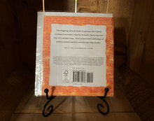 Load image into Gallery viewer, Image shows the back of the book/card, Animal Poems. The cover is white with a patterned orange and yellow boarder. It is displayed on a book stand.
